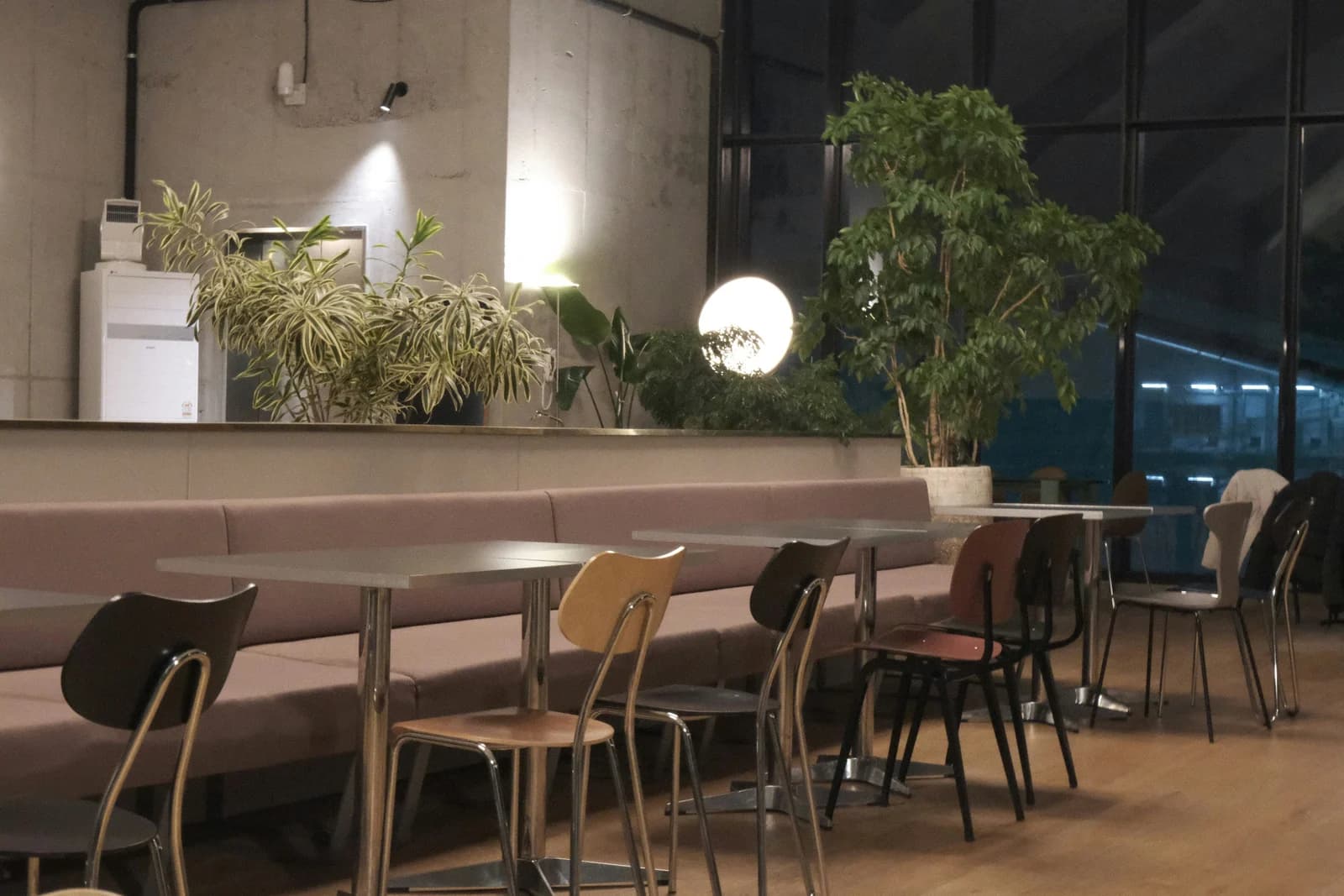 Desk with a screen lit at night, where an owner runs the prompts to check their AI visibility