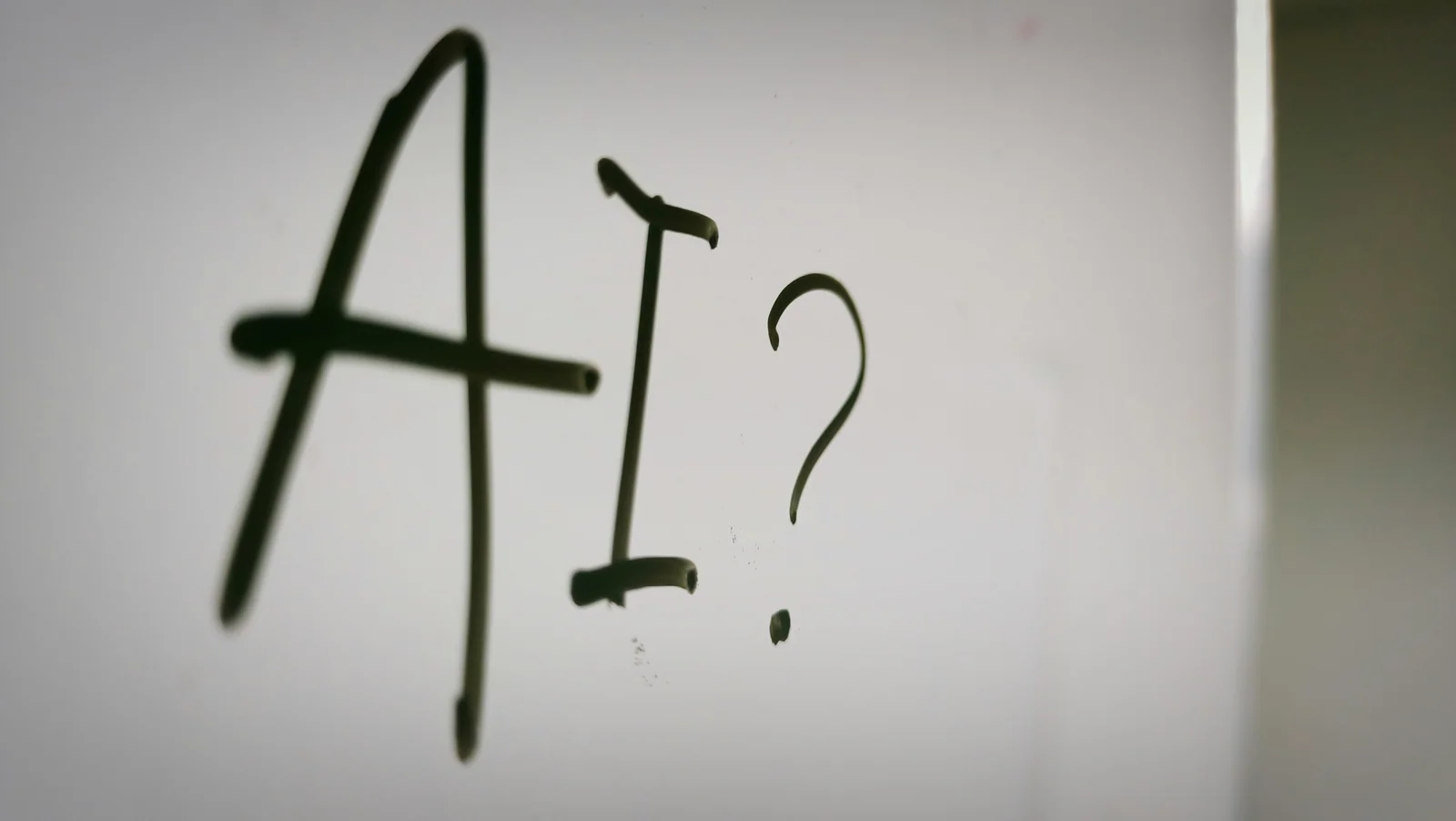 The letters AI followed by a question mark, drawn by hand on a fogged glass surface, standing in for the open question this article answers: what generative engines actually extract when they cite a page.