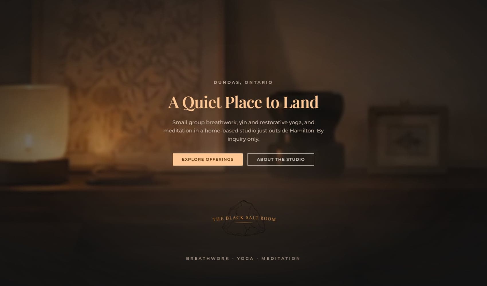 The Black Salt Room homepage hero: candlelit dark palette, a serif headline reading A Quiet Place to Land, and a hand-drawn salt-rock mark anchoring the page.