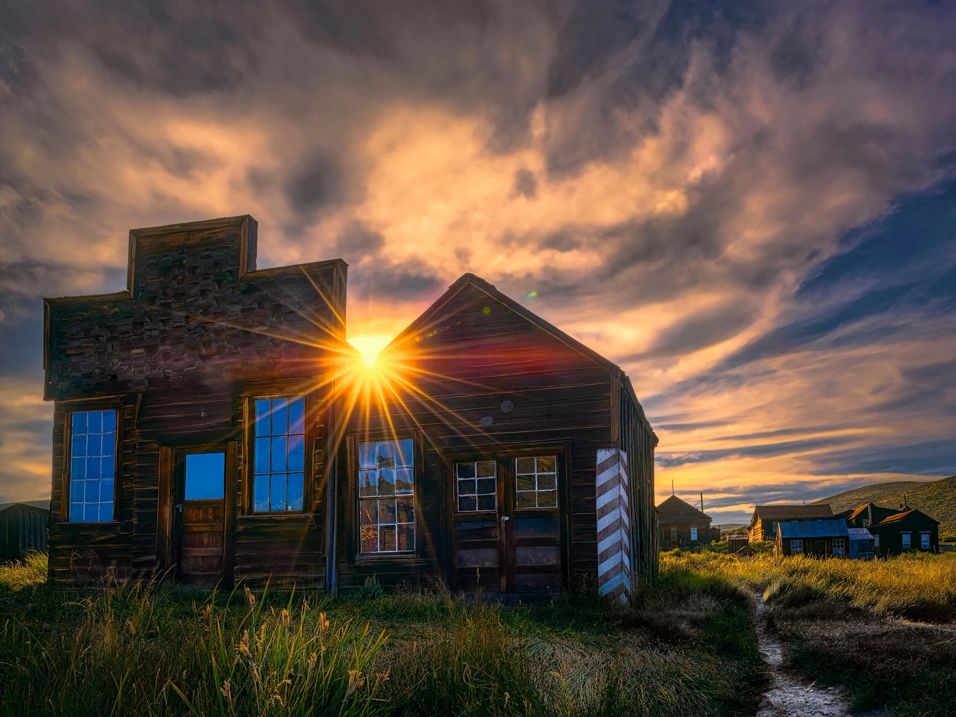 Sunset over the Dean Jeffries Barbershop in the Bodie ghost town, California, the heritage site Bodie Foundation preserves.