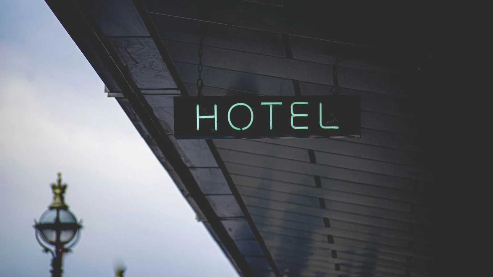 A glowing HOTEL sign at dusk, the property-side presence the website has to honestly represent for boutique hotel direct bookings to follow.