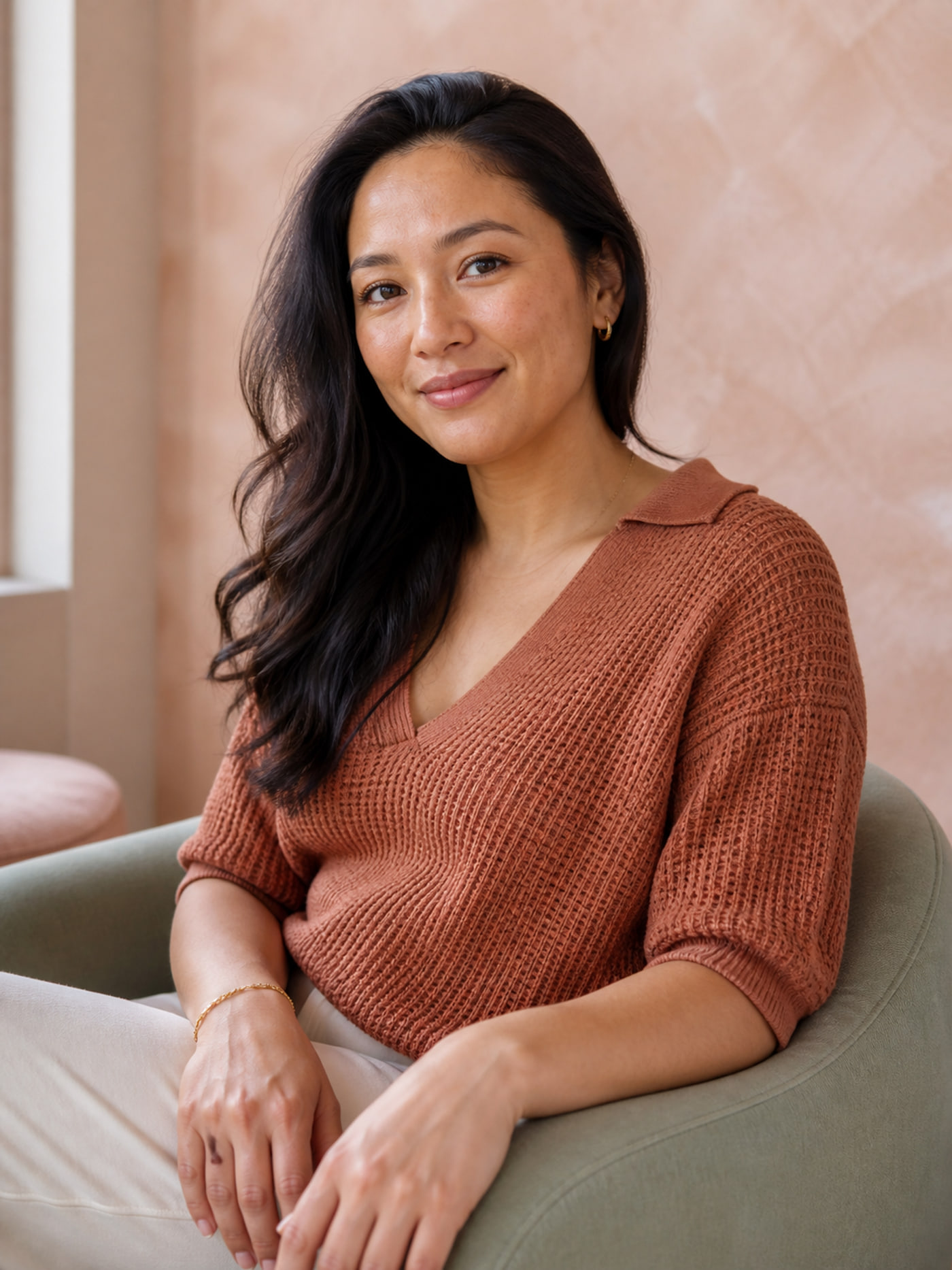 Maya seated in a sage chair after a texture-focused treatment series